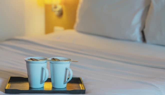 close-up-twin-welcome-coffee-cup-white-bed-hotel-room-hotel-well-hospitality-vacation-travel jcomp